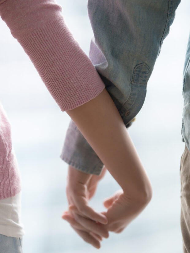 Young couple holding hands, closeup Love, support, family, rela
